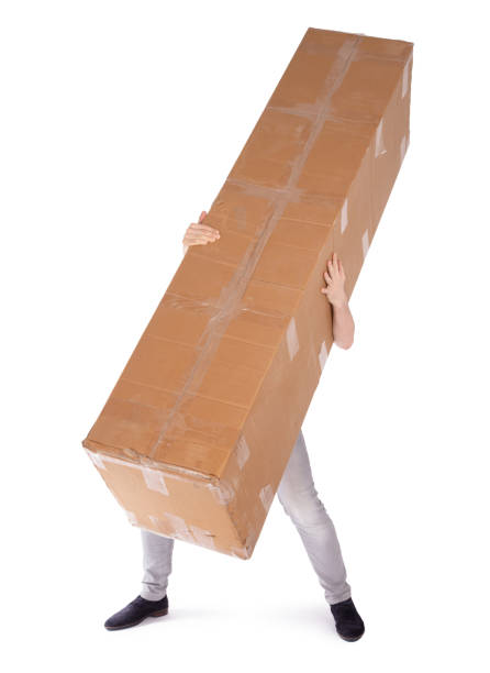 istock Man carrying a oversized cardboard box, isolated on white 1318979349