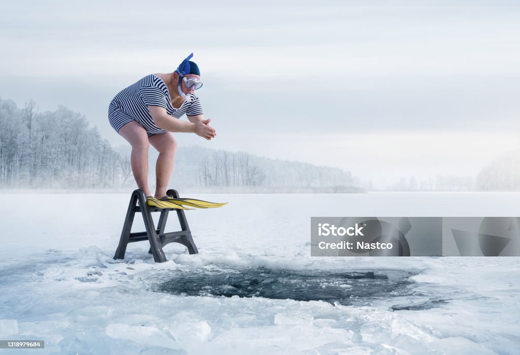 Fuunny overweight, retro swimmer about to jump into the ice hole Fuunny overweight, retro swimmer about to jump into the ice hole in the lake, with copy space Humor Stock Photo