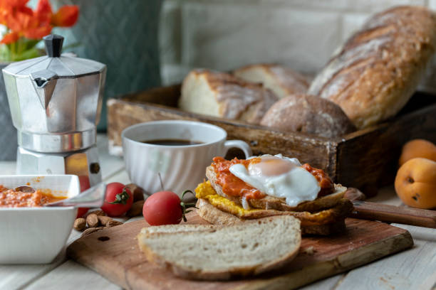 homemade healthy breakfast：egg, tomato sauce, slice of wholegrain bread and coffee