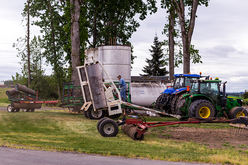 Silverton, Oregon, USA - May 17th, 2021: Caring for agricultural machinery at the end of the working day