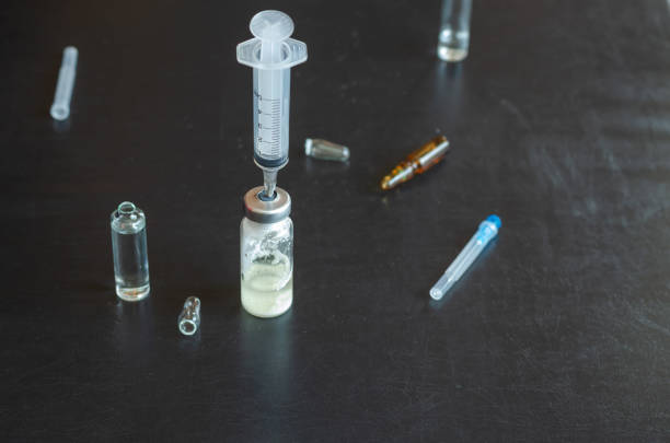 istock A syringe, three ampoules, and a bottle of white powder. 1318984572