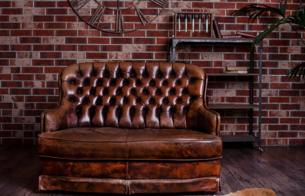 istock Old leather sofa. Brown furniture. Retro bed with a soft back 1318985876