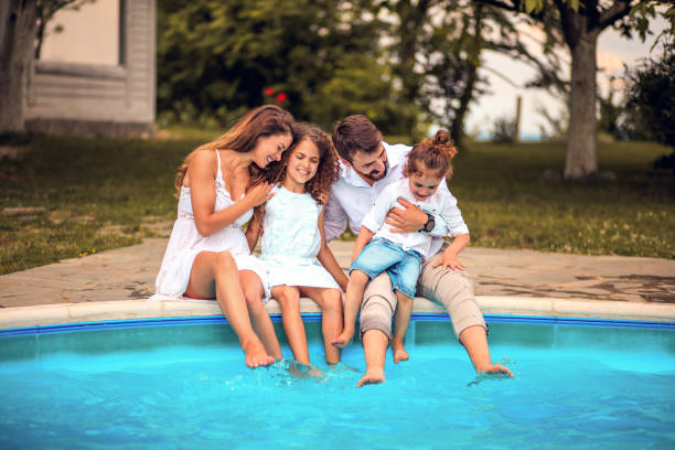 istock Family sitting by the pool. 1318986144