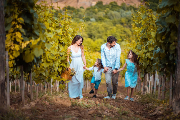 istock Family walking trough vineyard. 1318987129