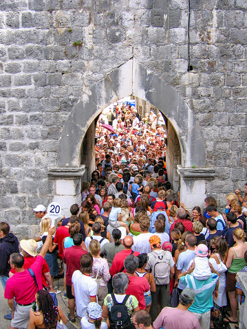 Dubrovnik, Croatia - July 16, 2005: Crowd of people cannot pass through the gates to old town. Tourists crowding at the entrance to old town in Dubrovnik, Croatia