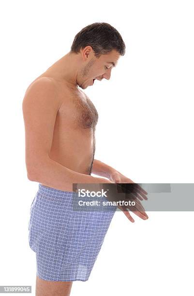 Młody Seksowny Przystojny Mężczyzna Patrząc W Jego Spodnie - zdjęcia stockowe i więcej obrazów Bez koszulki