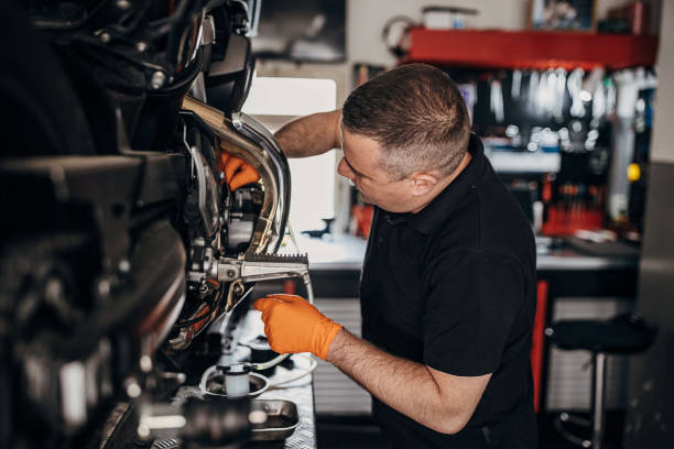 istock Male mechanic changing oil motorcycle 1318992309