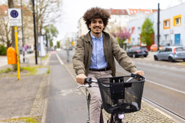 istock Young man riding his cycle in bicycle lane 1318992729