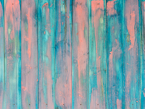 Strong color contrast weathered abstract wood background with lots of texture, grain, and character. Rows of nails at the top and bottom of the image make a frame for copy space.