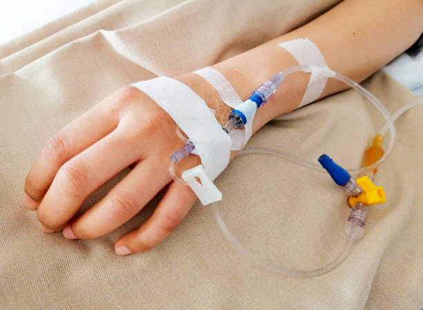 istock The patient is sleeping on the bed at the hospital with a saline solution line on hand. 1318994397