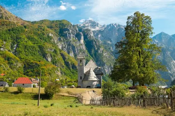 Beautiful views of the church in Theth village and the surrounding mountains. Theth National Park, Albania. The theme is nature, travel, exploring, Europe, Albania, Balkan, national parks, hiking.