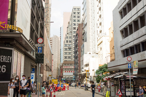 Tsim Sha Tsui, Hong Kong - 18 May 2021 : People on a busy street in Tsim Sha Tsui, a center of various shopping places and famous landmark of Hong Kong.