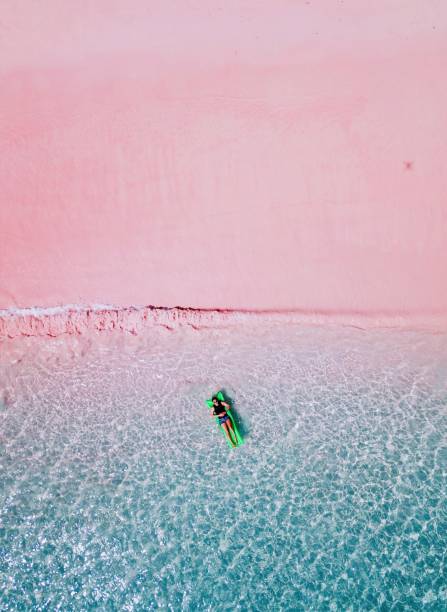 istock Pink beach and tuqouise sea 1318995830