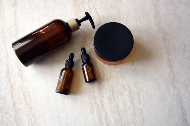 istock Cosmetic containers on a beige background. Brown bottles. Dispenser. 1318995853