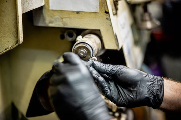 istock Wearing protective gloves and polishing high heel shoe sole on machine 1318995876