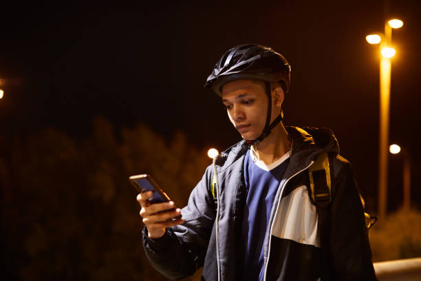 istock A young delivery person looking at his smartphone. 1318996615