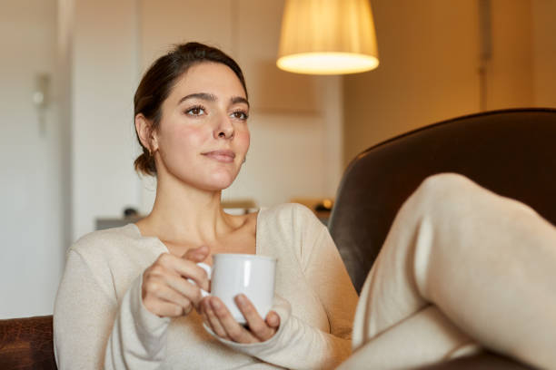 istock Young woman at home relaxing and drinking tea. 1318997070