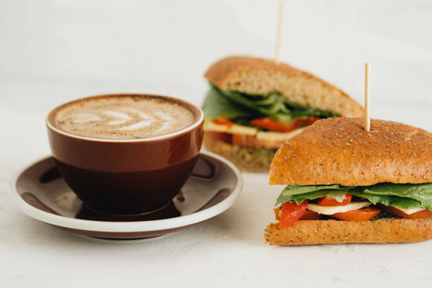 istock A cup of coffee and panini on white table 1318999786