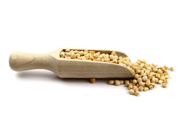 istock dried peas in wooden scoop isolated on white background 1319002601