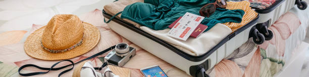 istock Open woman suitcase prepared for summer vacation 1319004941