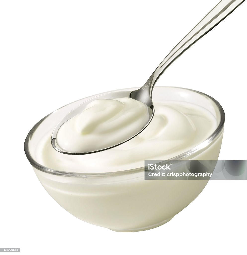 Bowl with yoghurt Nice product shot from a bowl and spoon with yoghurt. Yogurt Stock Photo