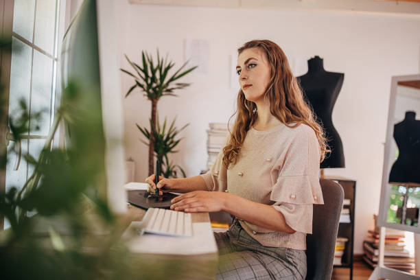 istock Female fashion designer working on computer 1319007719