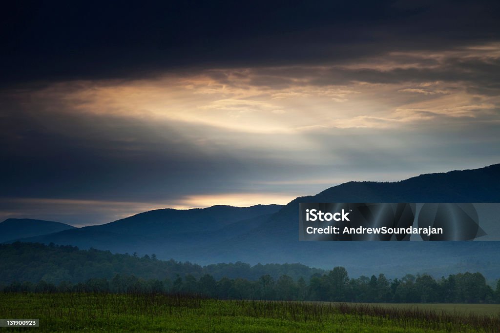 Break in the clouds Light breaking through storm clouds and illuminating the Cades Cove area of the Great Smoky Mountain National Park. Appalachia Stock Photo