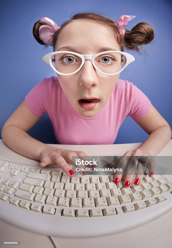 Nerdy girl with computer keyboard more computer nerds: Adolescence Stock Photo
