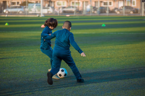 istock 2 young boys training hard on the football pitch 1319009699