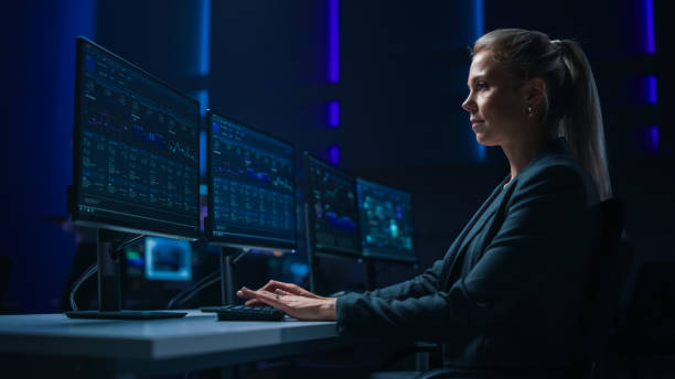 istock Confident Female Data Scientist Works on Personal Computer in Big Infrastructure Control Room. Stock Market Woman Specialist Uses Computer Showing Graphs, Charts, Information. Monitoring Room Team 1319010521