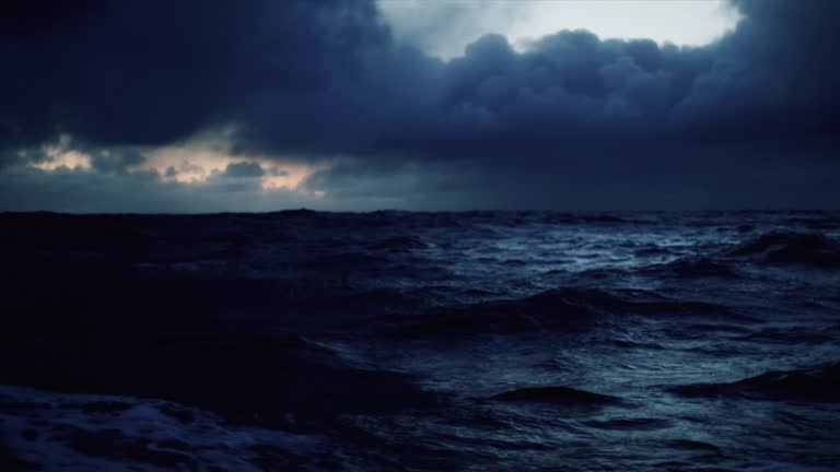 From a vessel in a blue rough sea at night: waves dark sea view