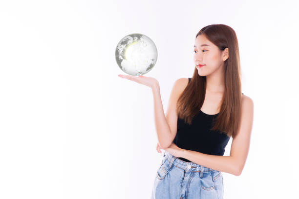 istock Student young girl holding small global while standing over isolated white background. Happiness woman looking at earth in own hands symbol for in the future. Lifestyle concept. 1319012279
