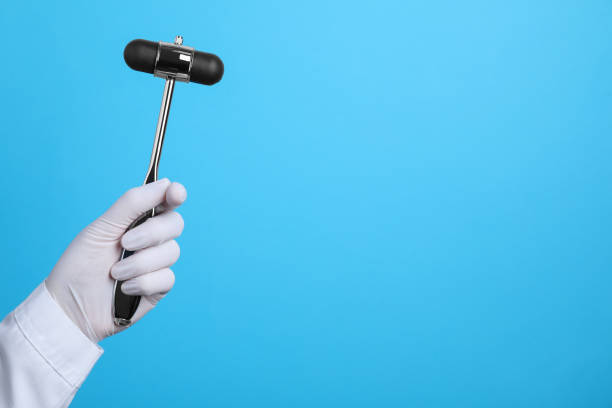 Doctor holding reflex hammer on light blue background, closeup with space for text. Nervous system diagnostic Doctor holding reflex hammer on light blue background, closeup with space for text. Nervous system diagnostic rubber mallet stock pictures, royalty-free photos & images