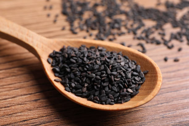 istock Black sesame seeds on wooden table, closeup 1319013011