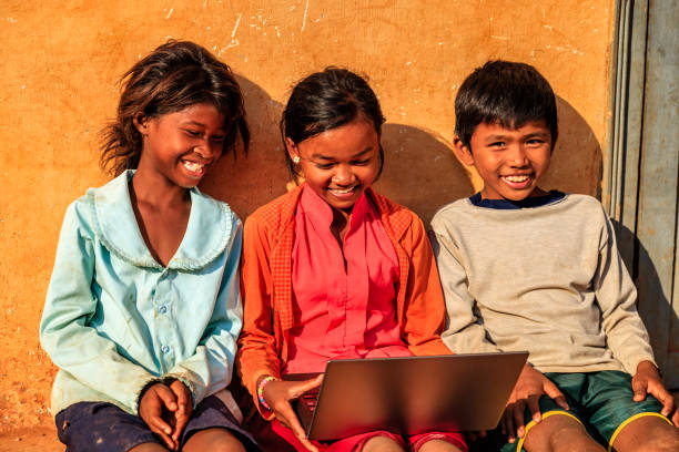 istock Happy Cambodian children using laptop on a schoolyard, Cambodia 1319014965