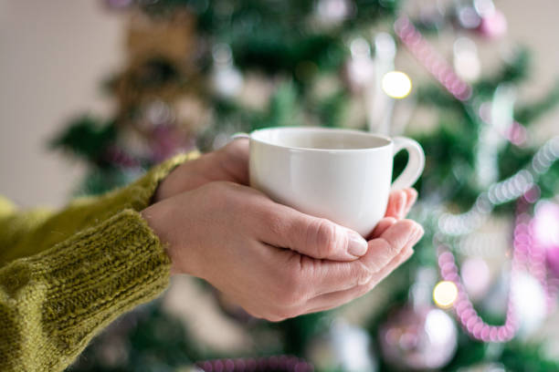 istock Female hands holding cup with hot tea or coffee 1319015009