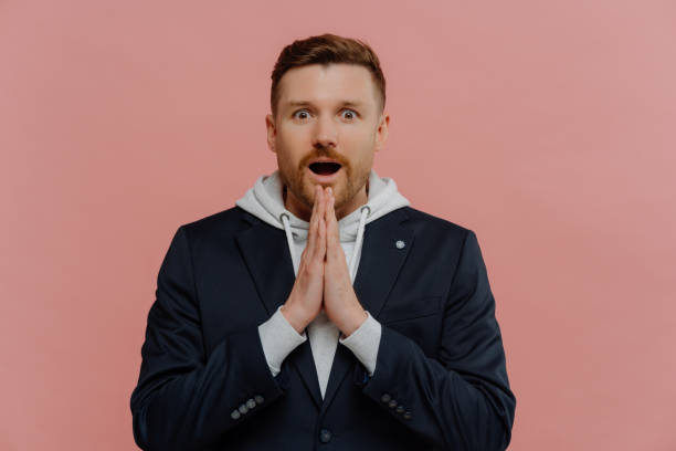 istock Amazed man keeping hands in praying gesture and asking for good luck 1319015365