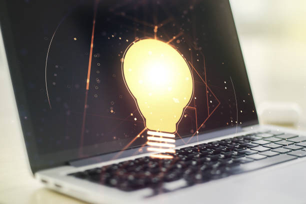 istock Double exposure of creative light bulb hologram on laptop background, research and development concept 1319015495