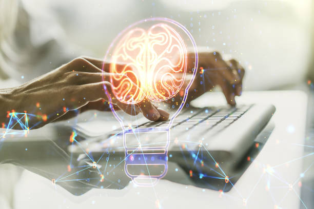 istock Double exposure of creative light bulb hologram with human brain and with hands typing on laptop on background, idea and brainstorming concept 1319016092