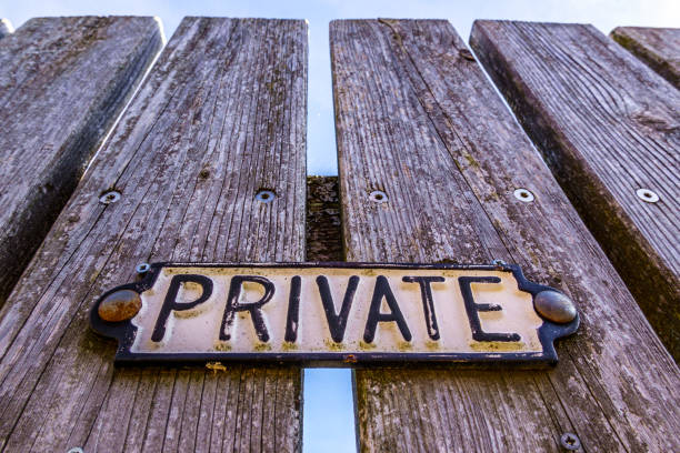 No parking warning street traffic sign on green old weathered rusty metal gate with leafy vine plant
