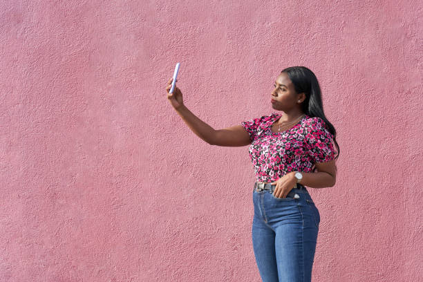 young afro woman taking a selfie with her smartphone