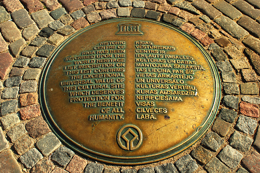 Riga, Latvia - July 10, 2017: Symbolic bronze manhole cover, a marker of the Riga old city center. Historic Centre of Riga is a UNESCO World Heritage Site.