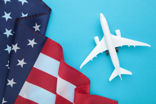 istock Toy plane with american flag on blue background. Travel 1319020832