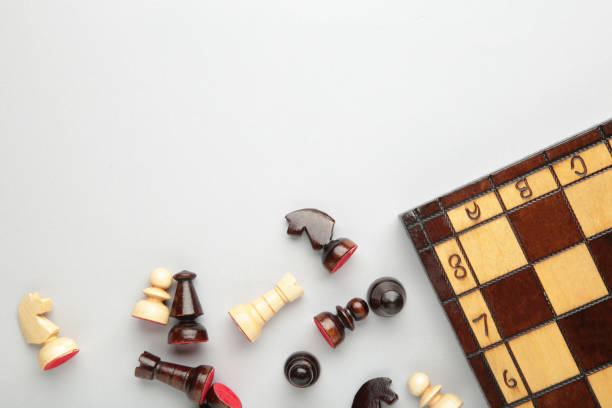 istock Symbol of competition. Chess board and chess figures on grey background top view copy space 1319021401
