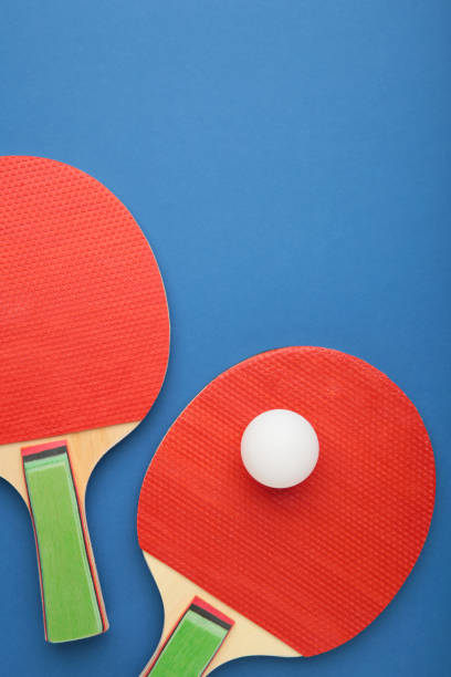 istock Ping pong rackets and ball on blue background with copy space. Vertical photo 1319021448