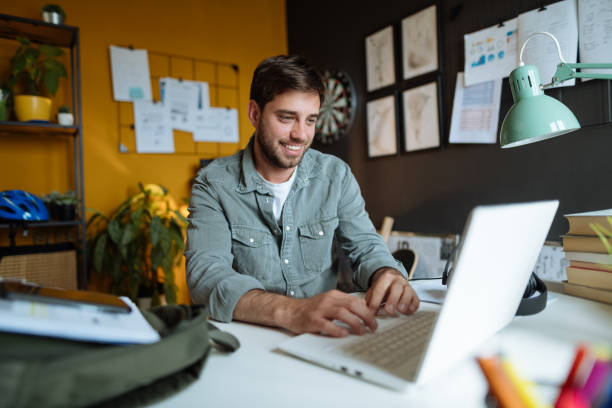 istock Smiling millennial businessman working on laptop 1319021838