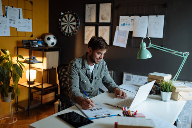 istock Millennial man working in modern office on laptop 1319021890