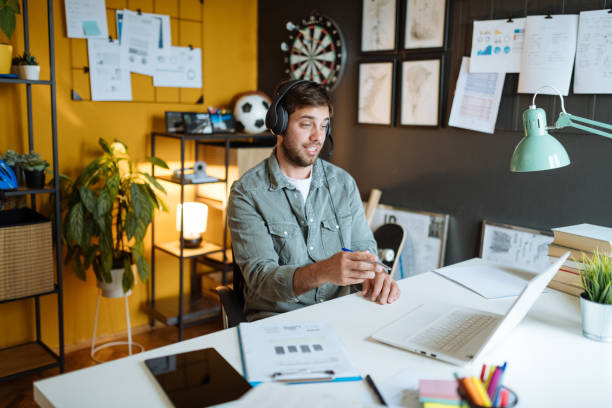 istock Millennial man working in modern office, having video call with business partners 1319021920