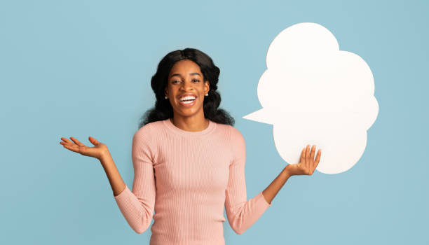 istock Cheerful Happy Black Woman Holding Empty Speech Bubble And Spreading Hands 1319023227