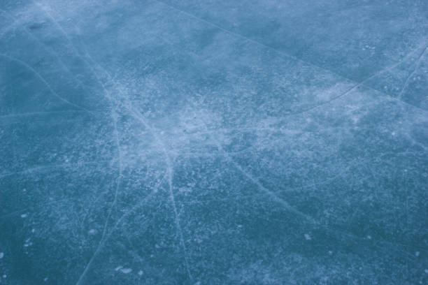 istock Blue cracked winter ice surface of frozen river 1319024667